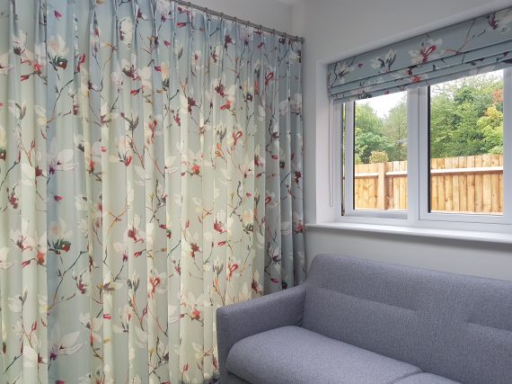 Waterfall roman blind stacked position next to curtain pole stainless steel with double pleat curtains